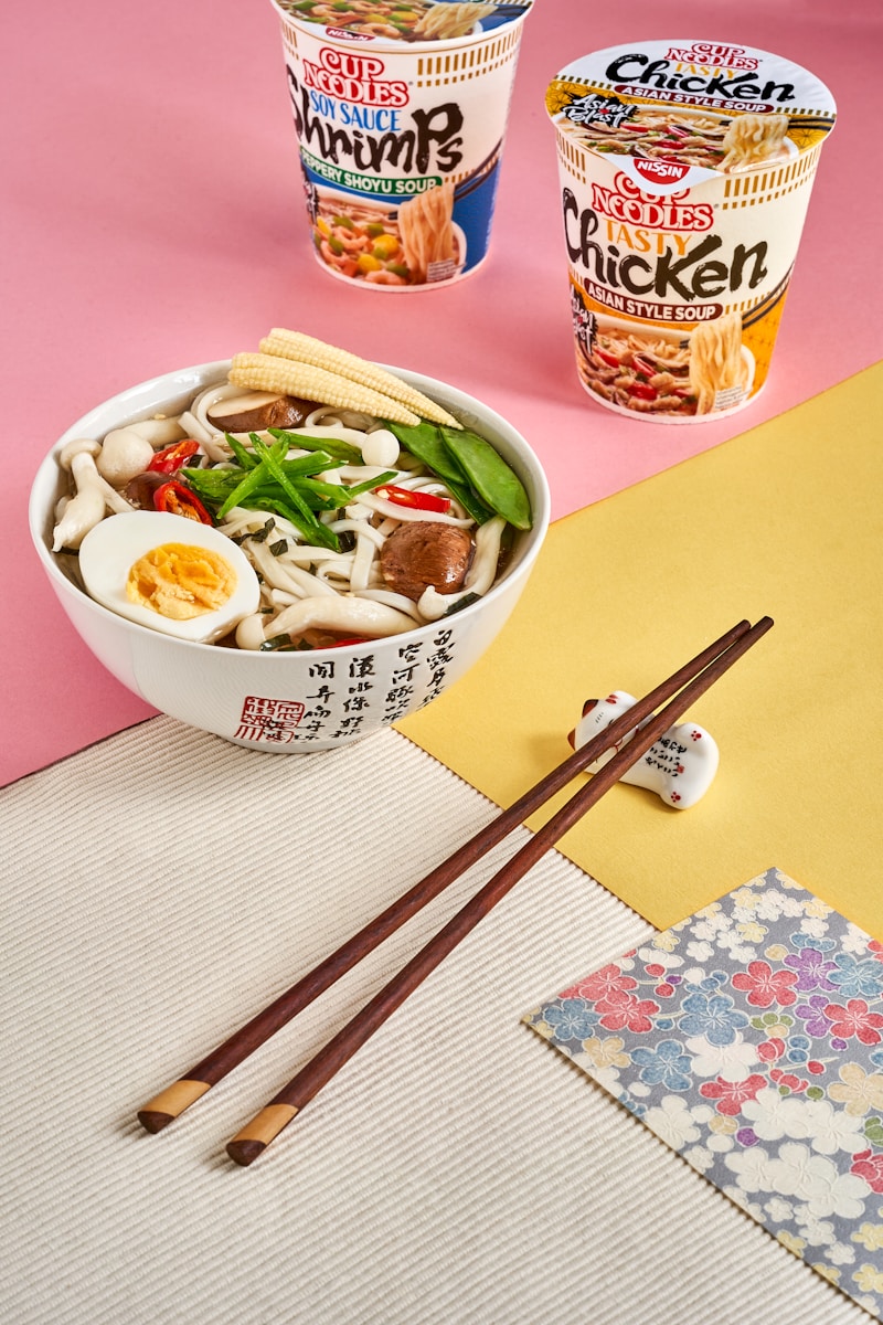 a bowl of soup with chopsticks and a bowl of soup